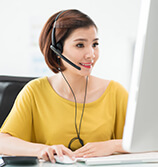 woman-in-yellow-blouse-at-computer-with-phone-headset