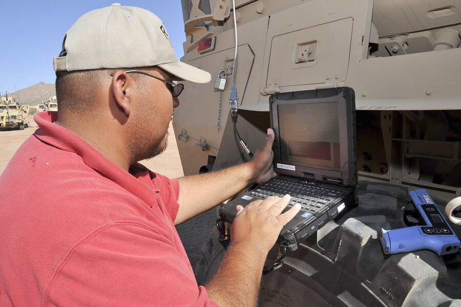 technician-programming-military-equipment-in-desert-setting